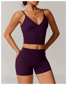 Close-up of plum purple recycled yoga bra with thin straps and V-neckline texture
