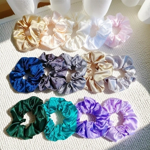 Flat lay of 14 pieces set premium satin silk scrunchies in various glossy pastel colors