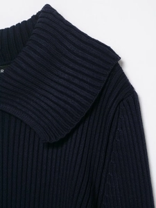 Detail of the navy blue ribbed knit cardigan showing the wide collar and texture