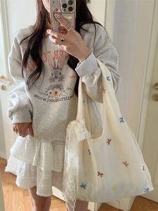 Chic beige tulle embroidered cherry tote bag styled with a lace tiered skirt