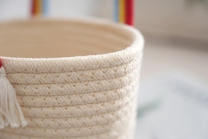 Detailed macro view of woven cotton rope texture with colorful rainbow striped handle