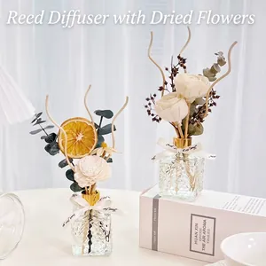 Preserved flower reed diffuser set in embossed glass bottles with sola flowers and orange slices