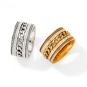 Macro detail of a wide two-tone chain ring featuring gold plating and double row diamonds