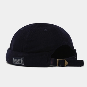 Detail view of corduroy docker hat featuring adjustable strap and woven side label