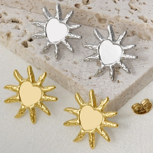 Detail of 304 stainless steel heart sun studs with irregular hammered texture and 18k gold plating