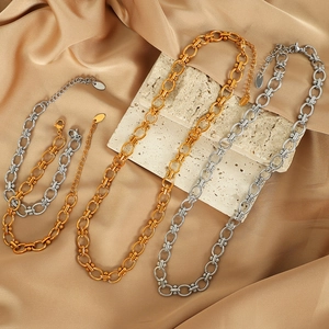 Elegant gold and silver titanium steel layered chain necklaces on silk background