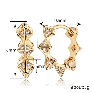 Golden minimalist geometric spike earrings with white zircon accents on white background