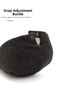 Detail of adjustable metal buckle on dark grey herringbone newsboy cap for custom fit