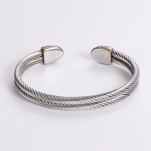 Dual-row cable open bangle in stainless steel with golden accents and crystal studs