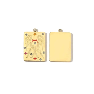 Macro shot of gold-plated rectangular zodiac pendant with crystals and smooth back side