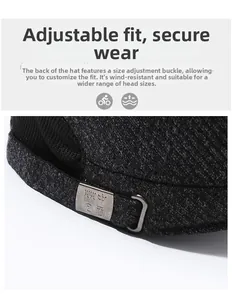 Detail of adjustable metal buckle on dark grey wool flat cap for secure fitting