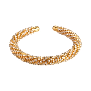 Golden open bangle with four rows of sparkling zircons and round spherical end caps