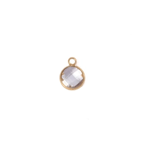 Close-up of a 7mm round faceted clear crystal pendant with golden metal bezel setting