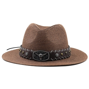 Close-up of leather hatband with vintage silver bull head and star studs on straw hat