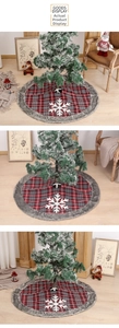 Detail of red and grey plaid Christmas tree skirt with snowflake and faux fur edge