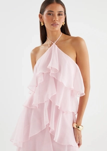 Detail of layered ruffle design and halter neck on a light pink chiffon summer dress