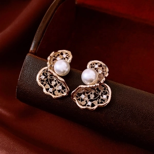 Macro detail of 18K gold plated pearl flower earring with sparkling zircon accents