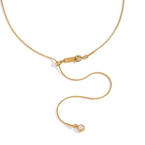 Detail view of gold snake chain necklace featuring sliding buckle and round zircon pendant