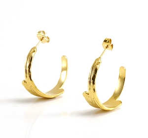 Detailed close-up of 18K gold plated C-shape earrings with irregular organic texture