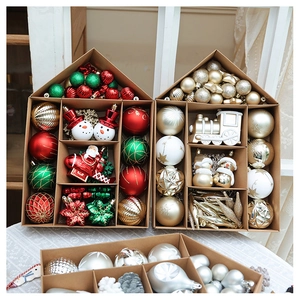 Detailed set of red and gold Christmas ornaments in a house-shaped cardboard box