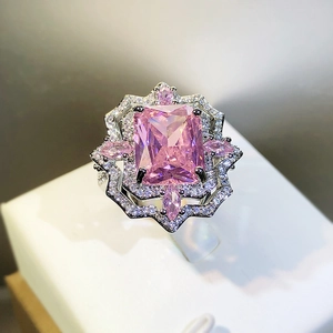 Ice cut pink carbon diamond ring with geometric silver setting on a light pedestal
