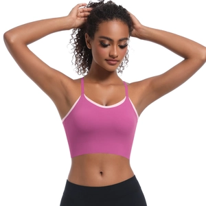 Detailed close-up of pink sports bra with cross straps and contrast piping on the neckline