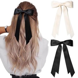 Elegant large silk bow hair clip set in black and cream for a retro feminine look