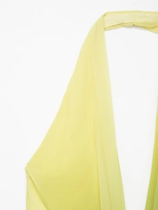 Close-up of yellow and green gradient chiffon fabric detail on halter neck floral dress
