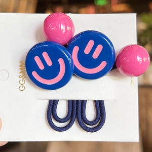 Close-up of blue smiley face charms and pink beads on high-elasticity hair ties