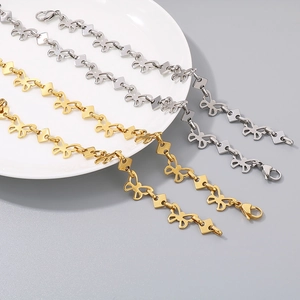 Detail of butterfly link bracelet in gold and silver finish with lobster clasp