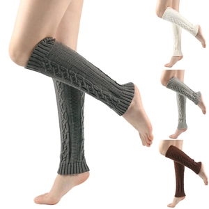 Detailed close-up showing thick cable knit texture in gray and beige leg warmers