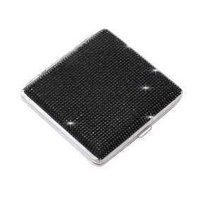 Detail of slim stainless steel square cigarette case with luxury black rhinestone crystals