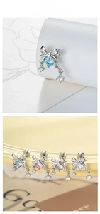 Detail of bow-shaped screw back earrings with colorful crystals in silver steel