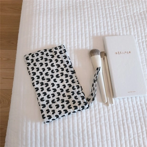 Detailed view of mini fabric bag with heart pattern featuring a small carry handle