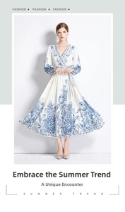 Detail of the elegant blue paisley pattern and V-neckline on this white bohemian maxi dress