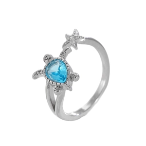 Silver sea turtle and starfish open ring featuring a blue teardrop gemstone for women