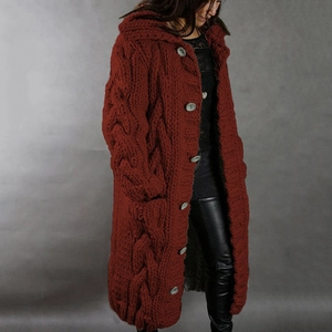 Close-up of deep wine red chunky knit cardigan with grey buttons and large side pockets