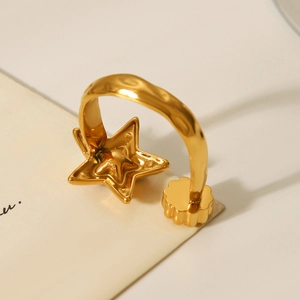 Detailed view of a gold star-shaped stainless steel open ring with zircon inlay