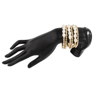 Detail of five-piece layered bracelet set with white pearls and gold metal beads