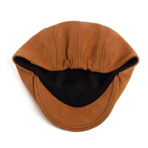 Detail of caramel brown suede beret showing black fabric lining and elastic closure
