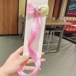 Detail of colorful gradient synthetic wig braid with a cute unicorn hair clip for kids