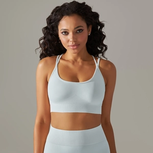 Detail of light blue seamless knitted yoga bra with cross back straps and ribbed band
