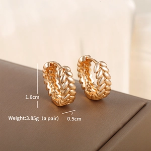 Detail view of gold geometric hoop earrings showing dimensions 1.6cm by 0.5cm and wheat texture