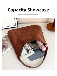 Spacious interior of a dark brown suede tote bag showing everyday essentials and storage