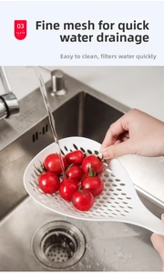 White kitchen skimmer with dense drainage holes rinsing fresh tomatoes in a sink