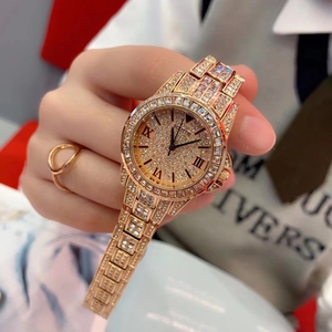 Detailed close-up of a rose gold luxury women's watch with crystals and Roman numerals