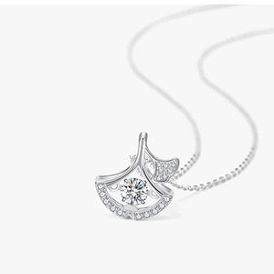 Detailed view of silver fan-shaped necklace pendant with dancing diamond setting