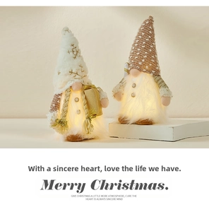 Close-up of glowing Christmas gnomes with warm LED lights and holiday accessories