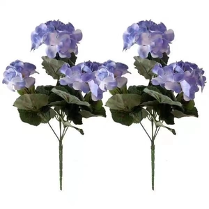 Detailed close-up of two blue-purple gradient artificial hydrangea bouquets with green leaves