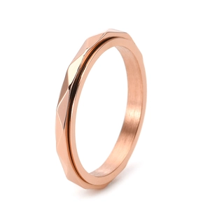 Minimalist rose gold stainless steel ring with a geometric faceted rotating design